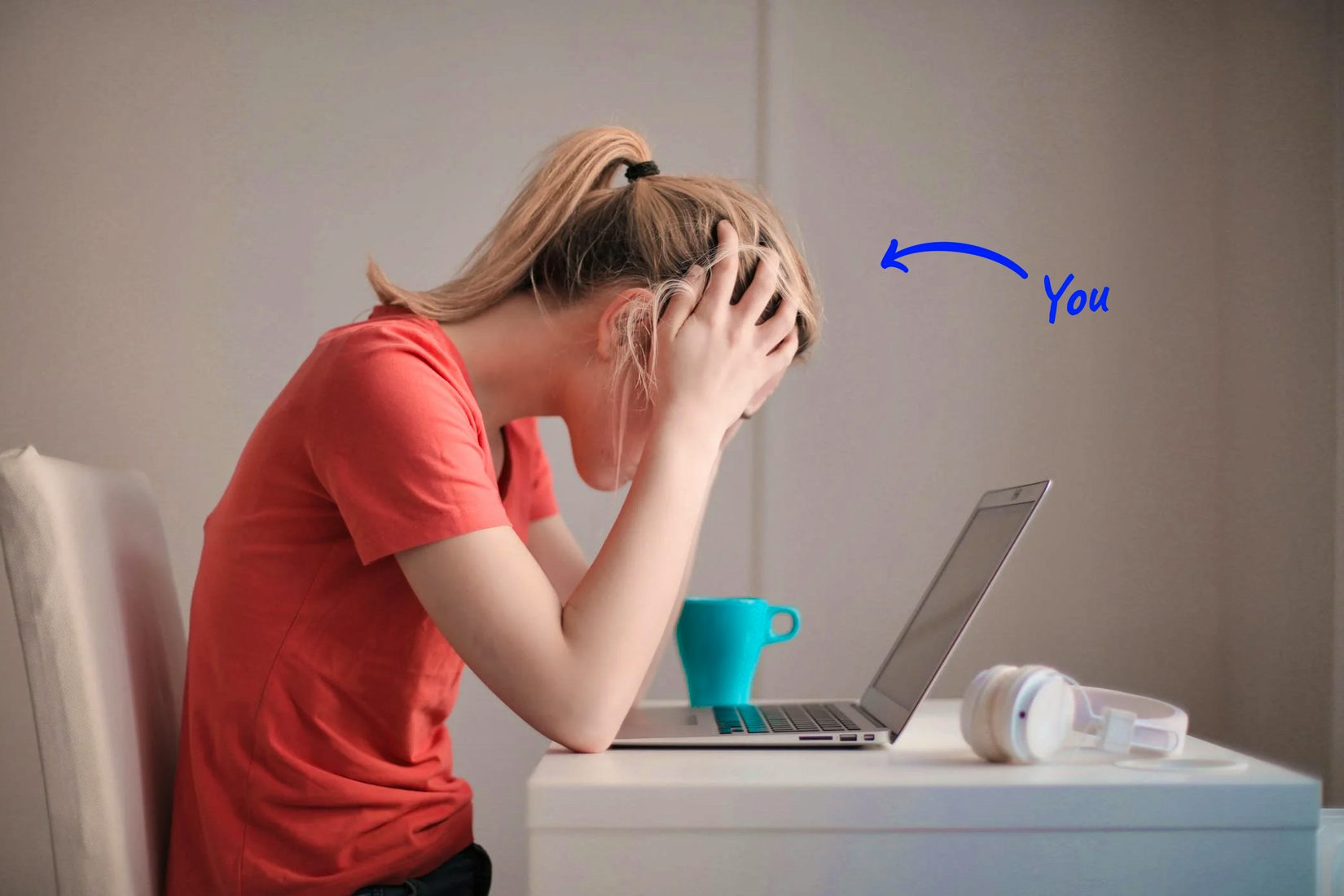 afrustrated woman looking at laptop with head in hands